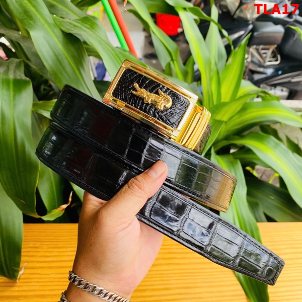 Thắt lưng da cá sấu FBA9B2 sang trọng vượt trội Hình ảnh thắt lưng FBA9B2 da cá sấu, khóa mạ vàng, bền bỉ, trên bàn gỗ với cây xanh.