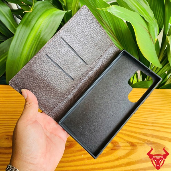 Phụ Kiện Cao Cấp Bền Bỉ Chắc Chắn Sang Trọng Đẳng Cấp Bao Bảo Vệ S24 Ultra Da Cá Sấu Nâu Đất Hình ảnh bao da S24 Ultra da cá sấu nâu đất, cầm trên tay trước lá cây, thể hiện sự cao cấp.