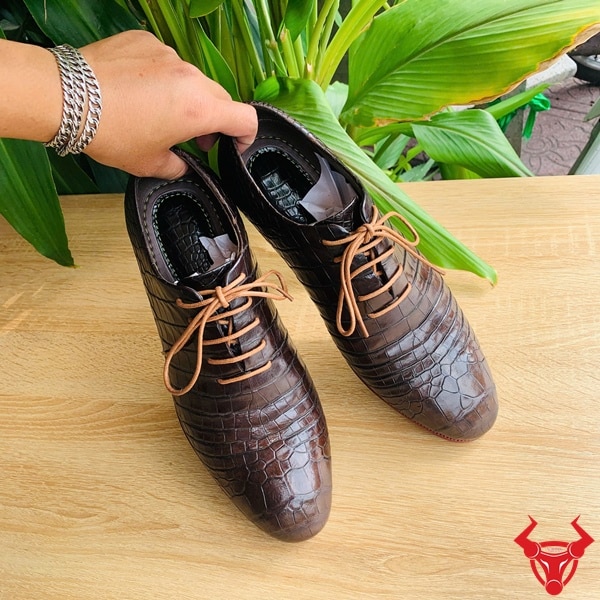 Lắp đế cao su mới cho giày da cá sấu thủ công.